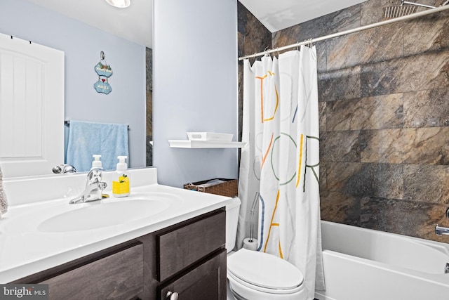 full bathroom featuring shower / bath combo with shower curtain, vanity, and toilet