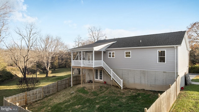 rear view of house with a yard and french doors