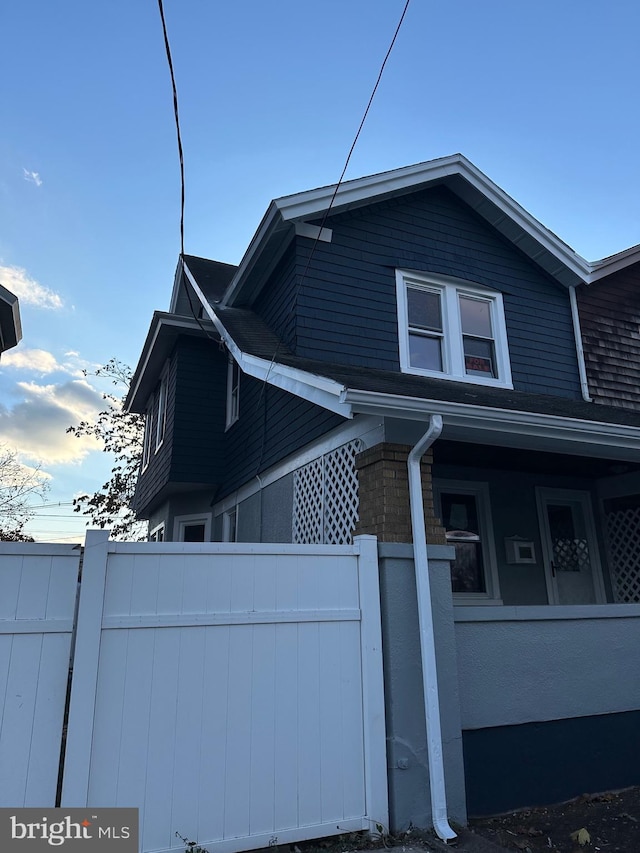 view of side of home with fence