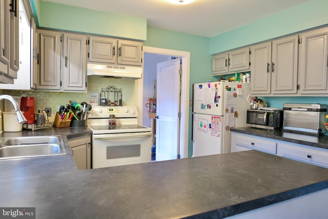 kitchen with tasteful backsplash, sink, and white appliances