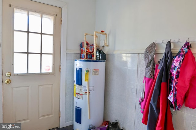 utility room featuring water heater