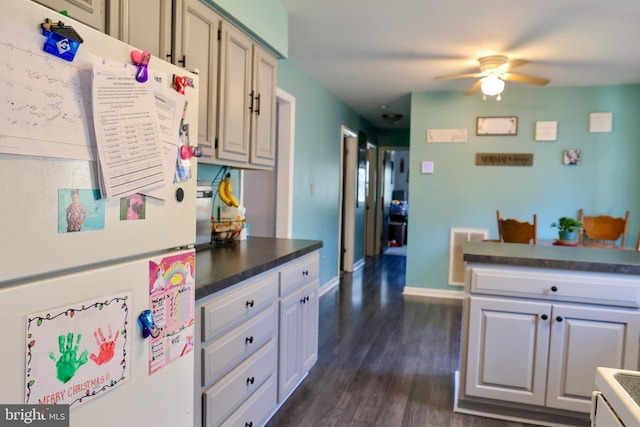 kitchen with ceiling fan, dark wood-type flooring, and white refrigerator