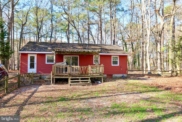 back of house with a deck