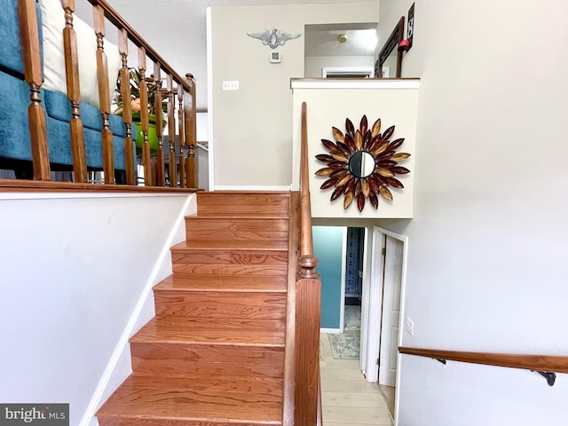 staircase with wood-type flooring