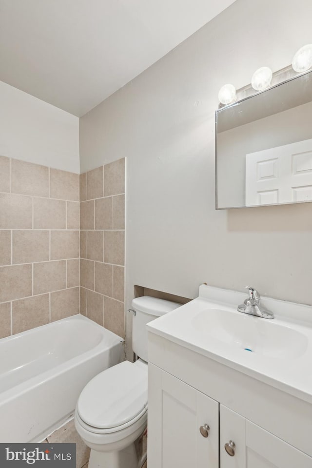 full bathroom with vanity, toilet, and tiled shower / bath