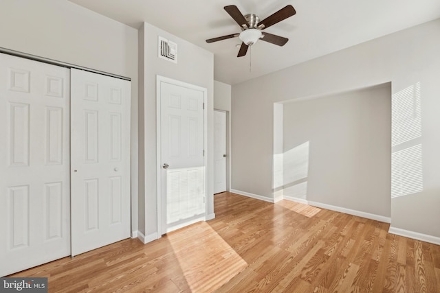 unfurnished bedroom featuring light wood-type flooring and ceiling fan