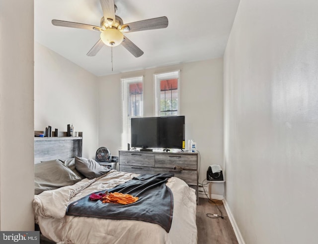 bedroom with ceiling fan and hardwood / wood-style flooring