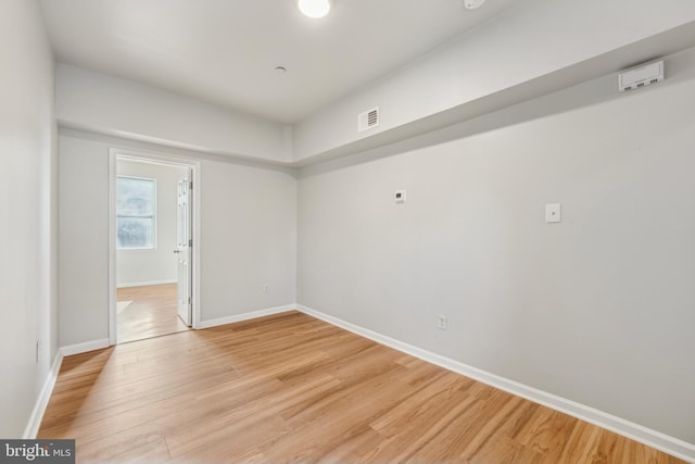 spare room featuring hardwood / wood-style flooring