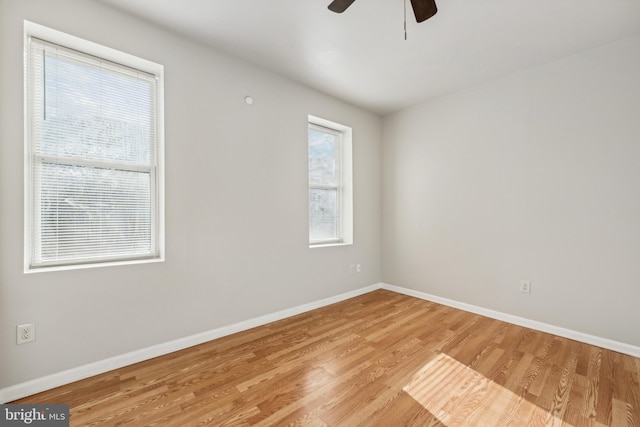 unfurnished room featuring plenty of natural light, ceiling fan, and light hardwood / wood-style flooring