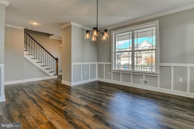 unfurnished dining area featuring dark hardwood / wood-style flooring, an inviting chandelier, and crown molding