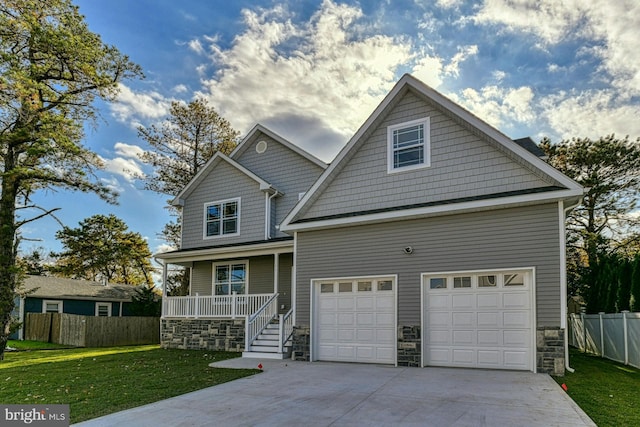 craftsman-style home featuring covered porch and a front lawn