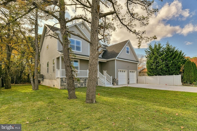 view of front of home featuring a front yard, a porch, and a garage