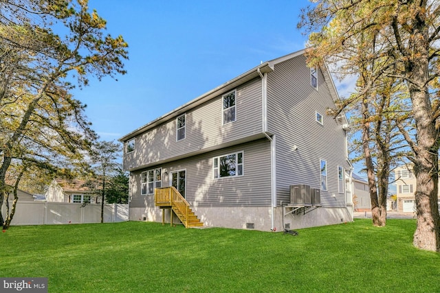 rear view of property with a yard