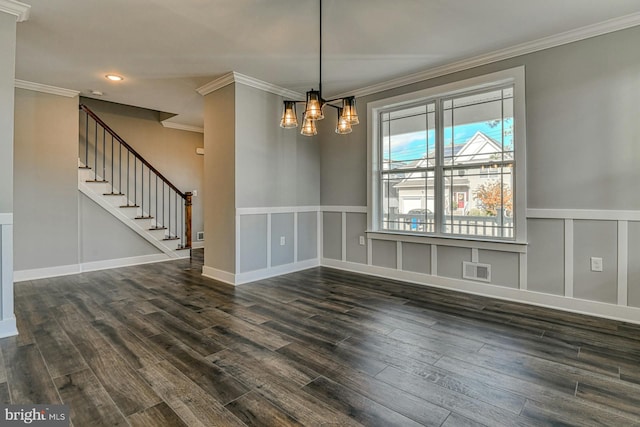 unfurnished dining area featuring dark wood-type flooring, a chandelier, and ornamental molding