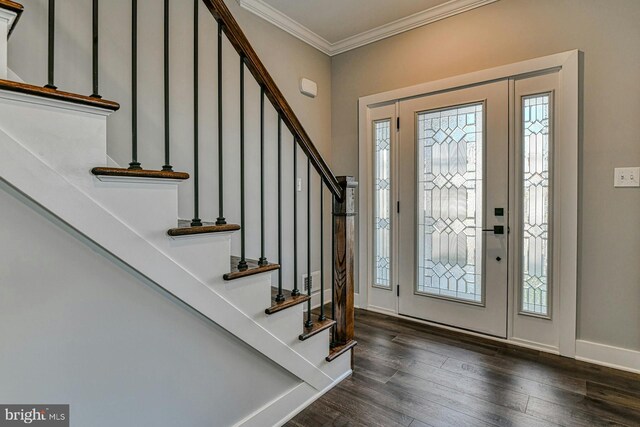 foyer with dark wood-type flooring and ornamental molding