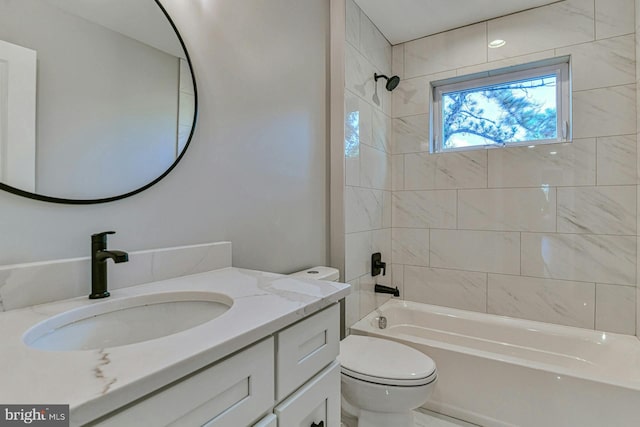 full bathroom with tiled shower / bath combo, toilet, and vanity