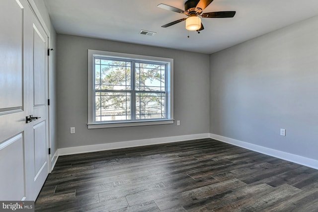 empty room with ceiling fan and dark wood-type flooring