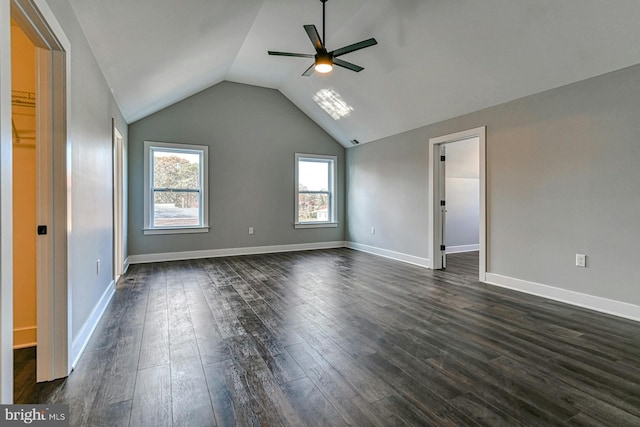 interior space featuring ceiling fan, dark wood-type flooring, and lofted ceiling