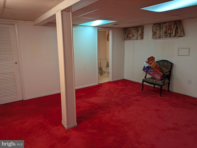 basement featuring carpet and a drop ceiling