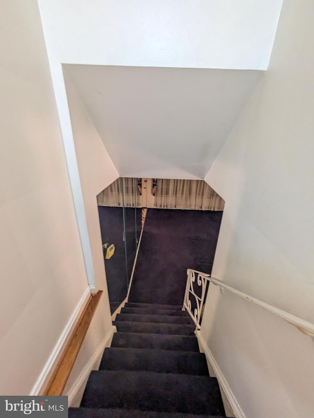 staircase featuring vaulted ceiling