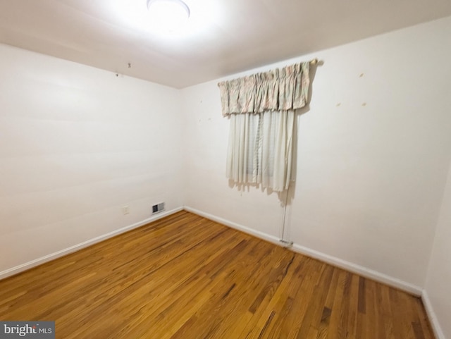 empty room with hardwood / wood-style floors