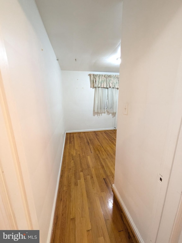 hallway featuring wood-type flooring