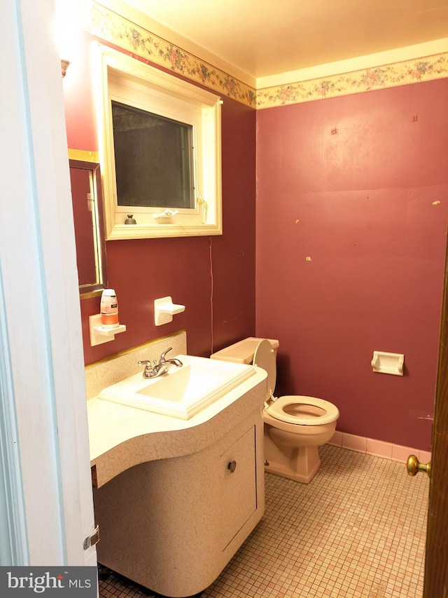 bathroom featuring tile patterned floors, vanity, and toilet