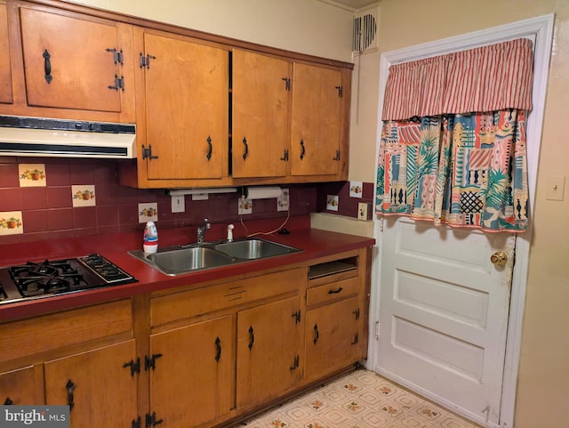 kitchen with ventilation hood, decorative backsplash, sink, and gas cooktop