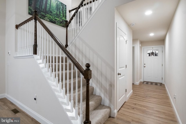 stairs with hardwood / wood-style flooring