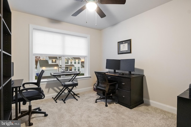 carpeted office space featuring ceiling fan