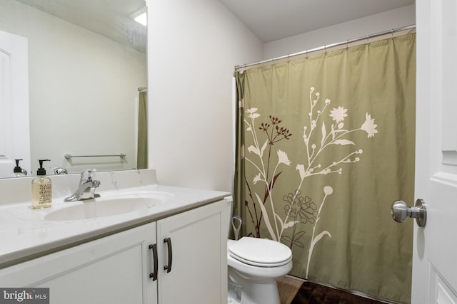 bathroom featuring a shower with curtain, hardwood / wood-style floors, vanity, and toilet