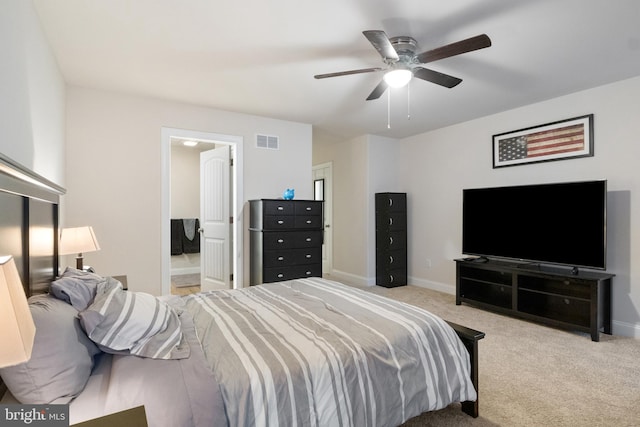 carpeted bedroom featuring connected bathroom and ceiling fan