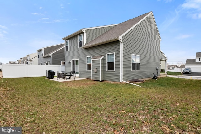 rear view of property with a patio area and a yard