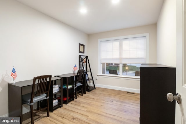 office space with light hardwood / wood-style flooring