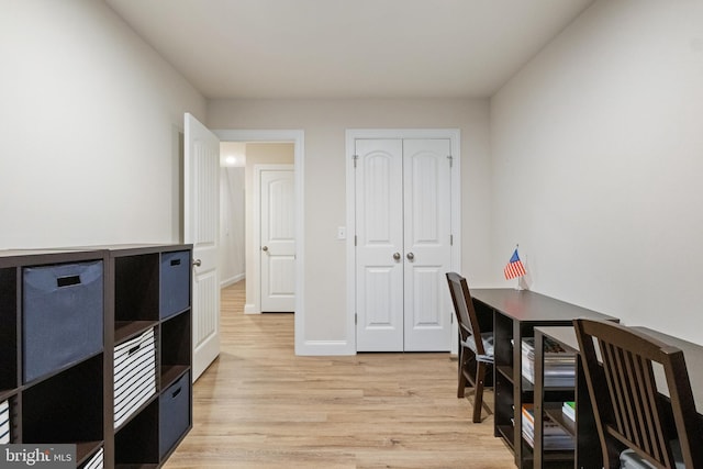 office with light wood-type flooring