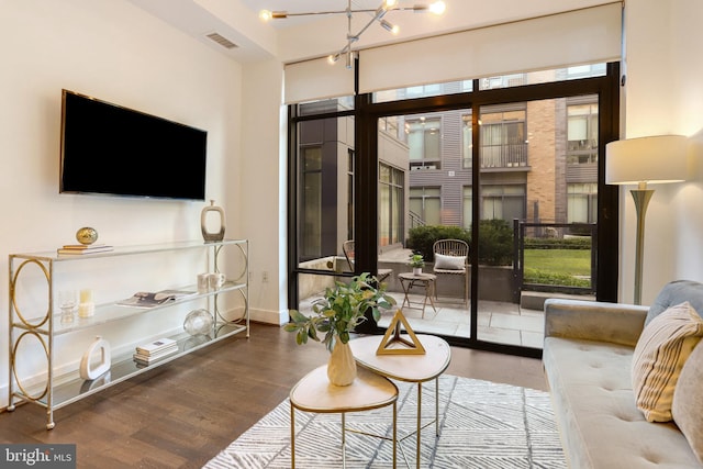 living room featuring hardwood / wood-style floors and a notable chandelier