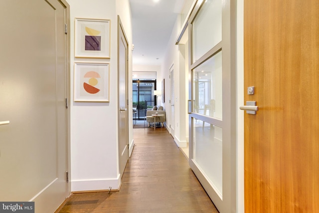 corridor with hardwood / wood-style floors