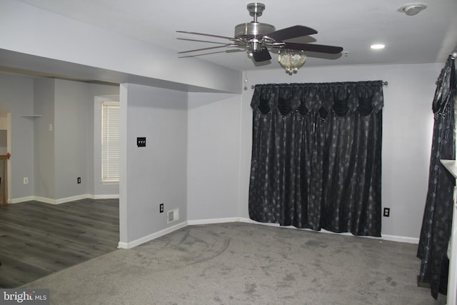 empty room with ceiling fan and dark hardwood / wood-style flooring