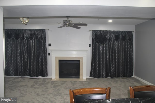 carpeted living room with ceiling fan