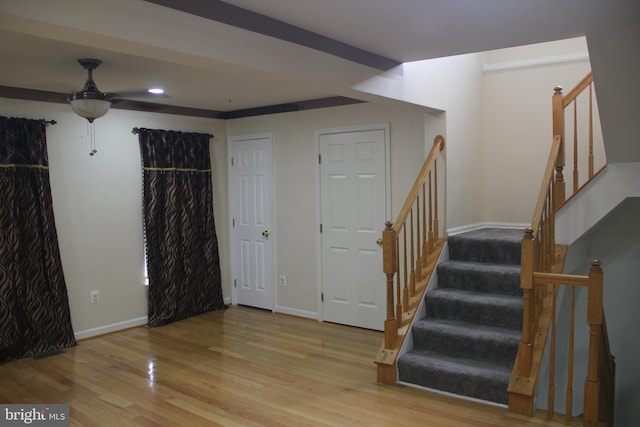 foyer entrance with ceiling fan and light hardwood / wood-style flooring