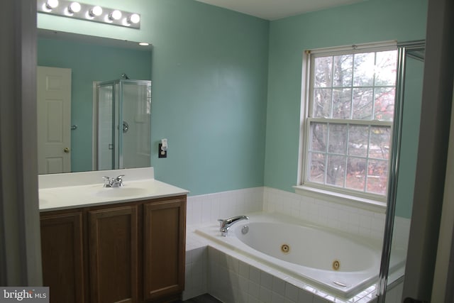 bathroom featuring vanity and shower with separate bathtub