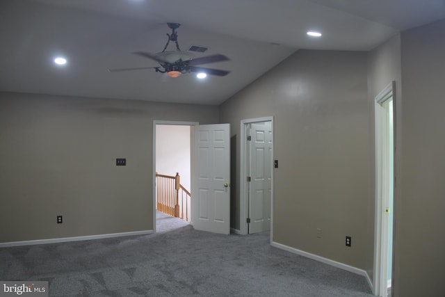 carpeted spare room with ceiling fan and lofted ceiling