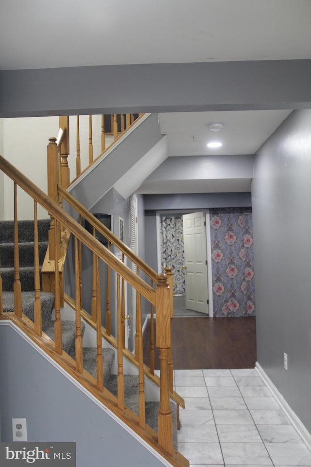 stairs featuring hardwood / wood-style floors