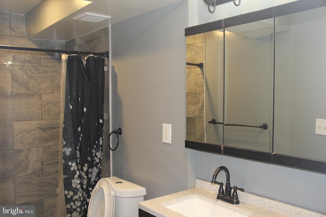 bathroom with vanity, toilet, and walk in shower