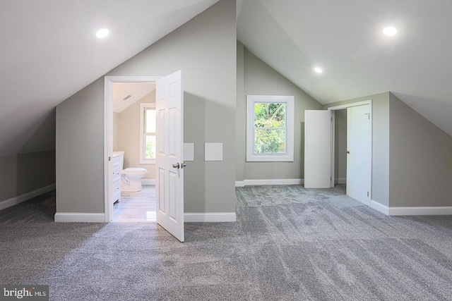 additional living space featuring carpet, a wealth of natural light, and lofted ceiling