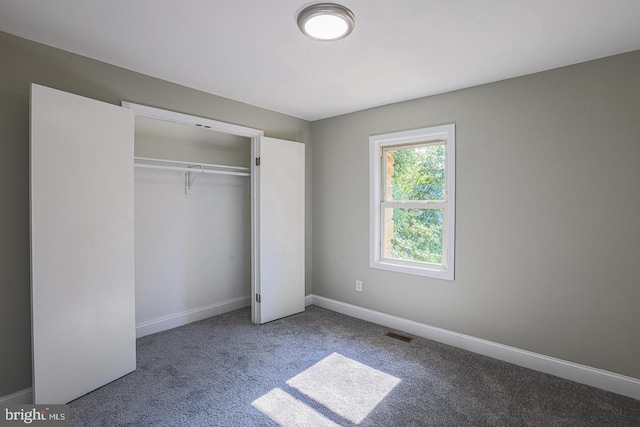 unfurnished bedroom featuring carpet floors and a closet