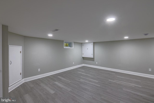 basement with light hardwood / wood-style floors