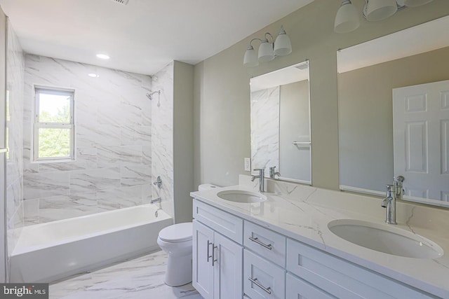 full bathroom with vanity, toilet, and tiled shower / bath