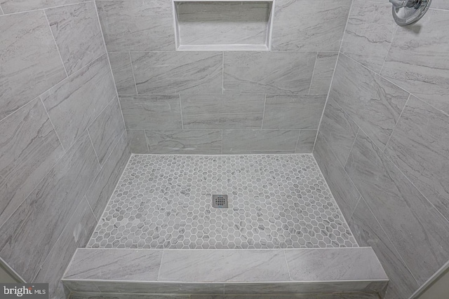 bathroom with a tile shower