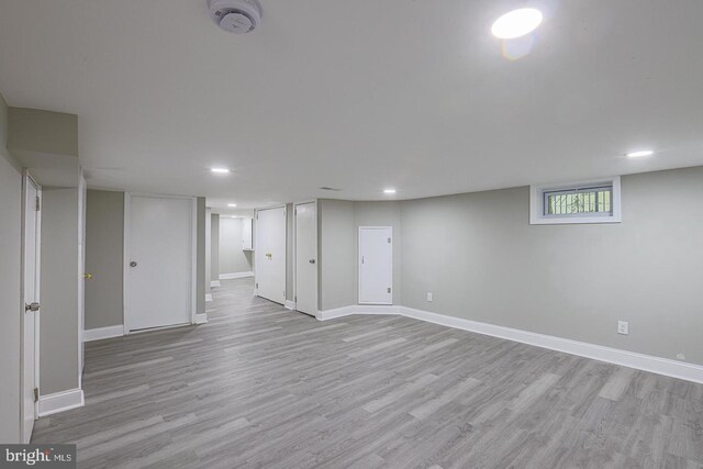 basement with light hardwood / wood-style flooring